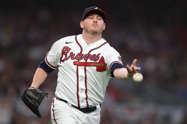 Tyler Matzek of the Atlanta Braves tosses to Freddie Freeman during the eighth inning against the Milwaukee Brewers in game four of the National...