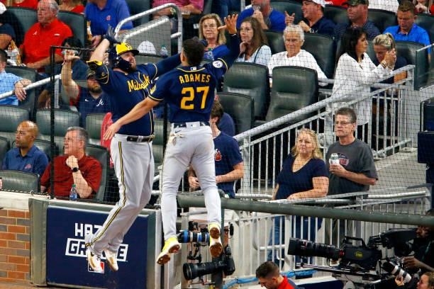 Willy Adames of the Milwaukee Brewers and Rowdy Tellez celebrate during the fifth inning against the Atlanta Braves in game four of the National...