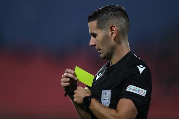 The referee Antonio Emanuel Carvalho Nobre of Portugal returns the yellow card ot his pocket during the 2022 UEFA European Under-21 Championship...