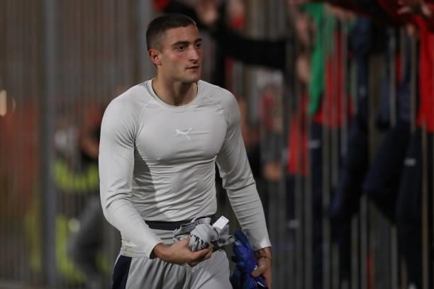 Stefano Turati of Italy removes his jersey to leave it as a gift for a fan during the 2022 UEFA European Under-21 Championship Qualifier match...