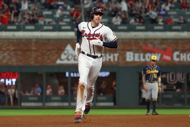 Freddie Freeman of the Atlanta Braves rounds the bases after hitting a home run during the eighth inning against the Milwaukee Brewers in game four...