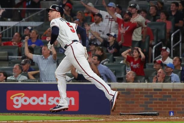 Freddie Freeman of the Atlanta Braves rounds the bases after hitting a home run during the eighth inning against the Milwaukee Brewers in game four...