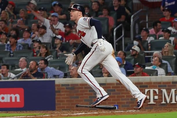 Freddie Freeman of the Atlanta Braves hits a home run during the eighth inning against the Milwaukee Brewers in game four of the National League...