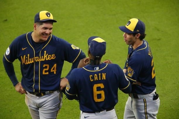 Avisail Garcia of the Milwaukee Brewers, Lorenzo Cain and Christian Yelich interact in game four of the National League Division Series against the...