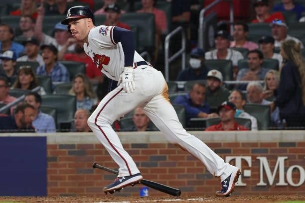 Freddie Freeman of the Atlanta Braves hits a home run during the eighth inning against the Milwaukee Brewers in game four of the National League...