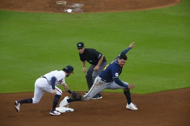 Dansby Swanson of the Atlanta Braves unable to pick off Avisail Garcia of the Milwaukee Brewers during the fourth inning in game four of the National...
