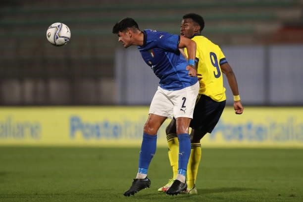 Raoul Bellanova of Italy heads the ball clear from Anthony Elanga of Sweden during the 2022 UEFA European Under-21 Championship Qualifier match...