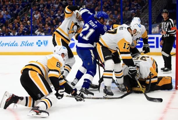 Tristan Jarry of the Pittsburgh Penguins stops a shot from Brayden Point of the Tampa Bay Lightning during the first period of a game at Amalie Arena...