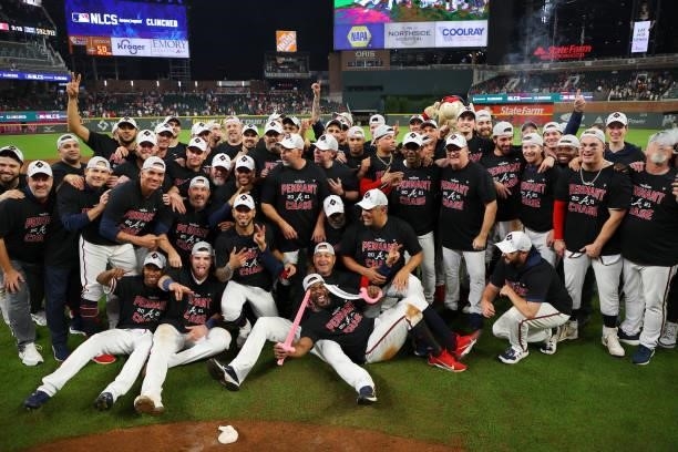 The Atlanta Braves pose for a photo after defeating the Milwaukee Brewers 5-4 in game four of the National League Division Series at Truist Park on...