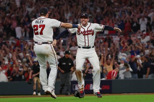 Freddie Freeman of the Atlanta Braves celebrates with Austin Riley after defeating the Milwaukee Brewers 5-4 in game four of the National League...