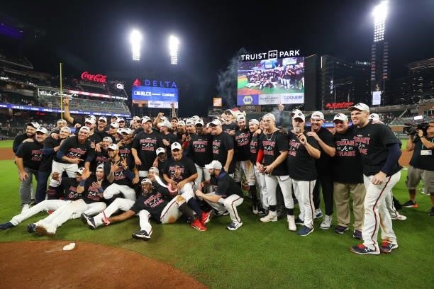 The Atlanta Braves pose for a photo after defeating the Milwaukee Brewers 5-4 in game four of the National League Division Series at Truist Park on...