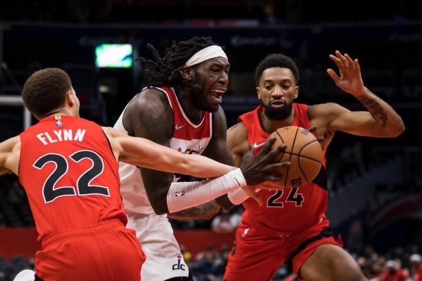 Montrezl Harrell of the Washington Wizards goes to the basket against Malachi Flynn and Khem Birch of the Toronto Raptors during the second half at...