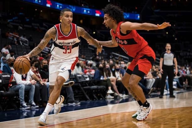 Kyle Kuzma of the Washington Wizards handles the ball against Justin Champagnie of the Toronto Raptors during the second half at Capital One Arena on...
