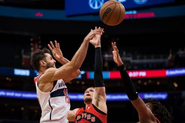 Raul Neto of the Washington Wizards passes the ball against Malachi Flynn and Freddie Gillespie of the Toronto Raptors during the second half at...