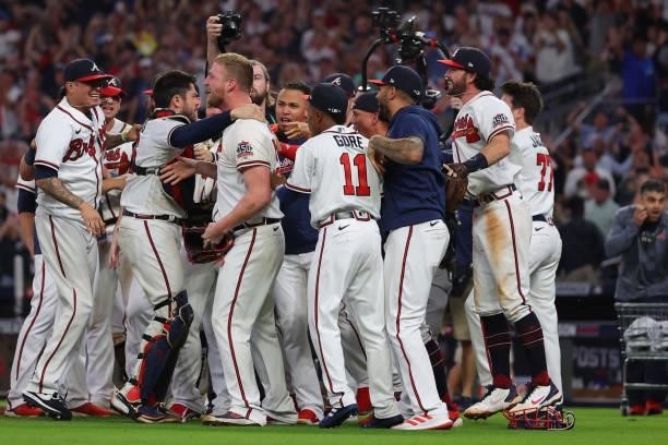 The Atlanta Braves celebrate after defeating the Milwaukee Brewers 5-4 in game four of the National League Division Series at Truist Park on October...