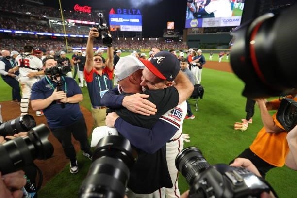 Brian Snitker and Freddie Freeman of the Atlanta Braves celebrate post game following their win over the Milwaukee Brewers in game four of the...