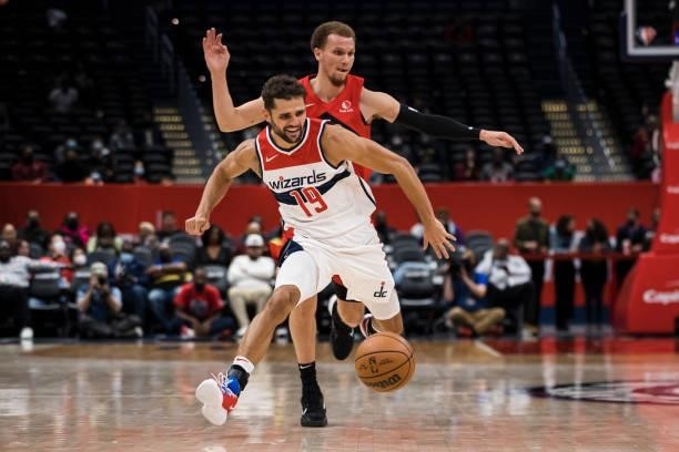 Raul Neto of the Washington Wizards handles the ball in front of Malachi Flynn of the Toronto Raptors during the second half at Capital One Arena on...