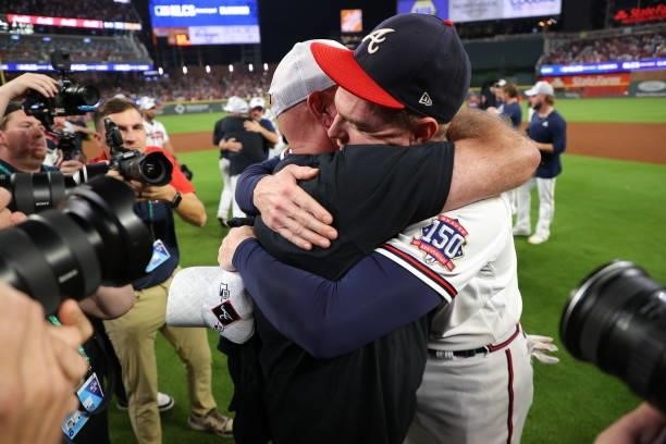 Brian Snitker and Freddie Freeman of the Atlanta Braves celebrate post game following their win over the Milwaukee Brewers in game four of the...