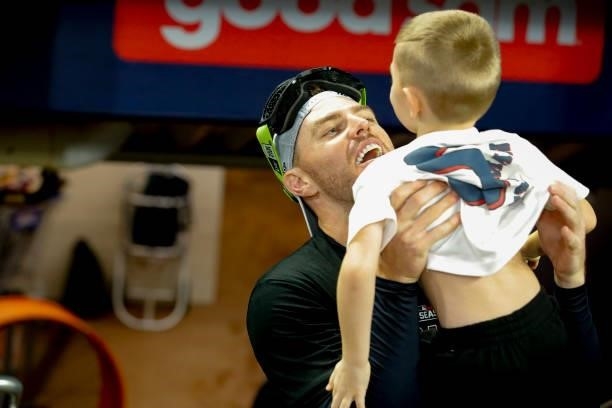 Freddie Freeman of the Atlanta Braves celebrates with his son Charlie following the win over the Milwaukee Brewers in game four of the National...