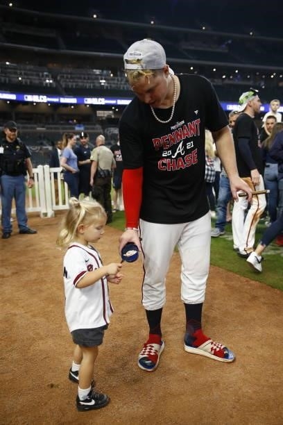 Joc Pederson of the Atlanta Braves celebrates with his daughter following the win over Milwaukee Brewers in game four of the National League Division...