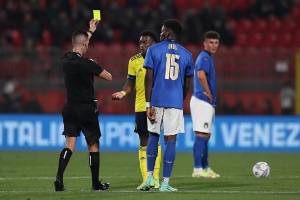 Caleb Okoli of Italy looks on as Anthony Elanga of Sweden is shown a yellow card by the referee Antonio Emanuel Carvalho Nobre of Portugal for his...