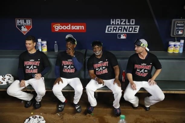 Ron Washington, Eric Young, and Josh Tomlin sit in the dugout following the win over the Milwaukee Brewers in game four of the National League...