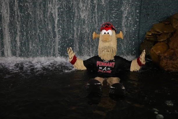 Blooper celebrates in the fountain following the win over the Milwaukee Brewers 5-4 in game four of the National League Division Series at Truist...