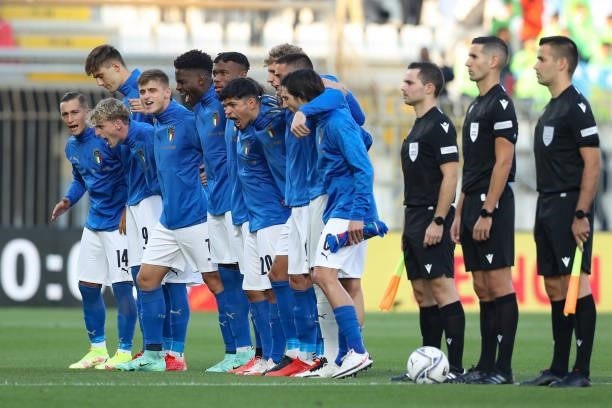 The Italy players sing out loud the last line of the National anthem prior to kick off in the 2022 UEFA European Under-21 Championship Qualifier...