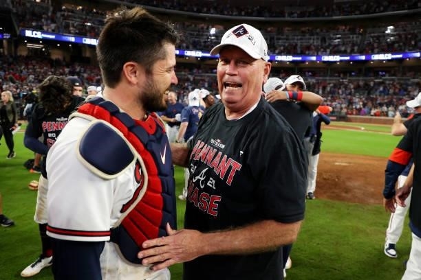 Brian Snitker and Travis d'Arnaud of the Atlanta Braves celebrate post game following the win over the Milwaukee Brewers in game four of the National...