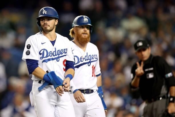 Gavin Lux and Justin Turner of the Los Angeles Dodgers walk to the dugout during the third inning in game 4 of the National League Division Series...
