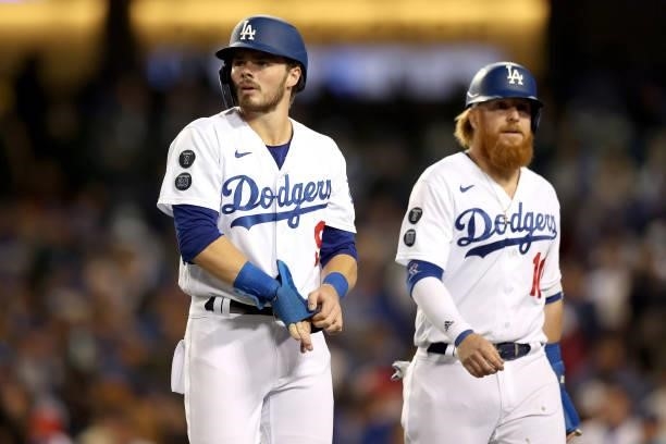 Gavin Lux and Justin Turner of the Los Angeles Dodgers walk to the dugout during the third inning in game 4 of the National League Division Series...