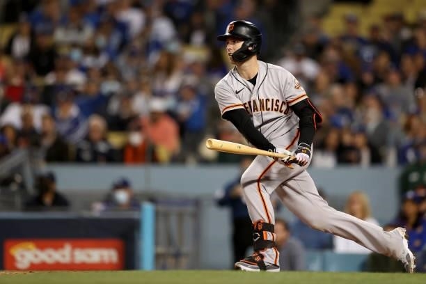 Buster Posey of the San Francisco Giants watches his ground out against the Los Angeles Dodgers during the fourth inning in game 4 of the National...