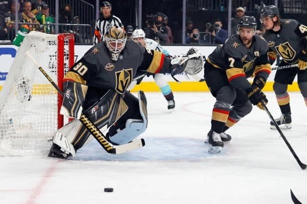 Robin Lehner and Alex Pietrangelo of the Vegas Golden Knights defend against the Seattle Kraken during the first period of the Kraken's inaugural...