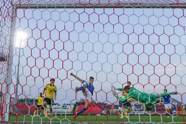 Lorenzo Lucca of Italy fires the ball past Samuel Brolin of Sweden to give the side a 1-0 lead during the 2022 UEFA European Under-21 Championship...