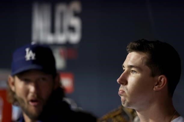 Clayton Kershaw and Walker Buehler of the Los Angeles Dodgers look on from the dugout against the San Francisco Giants during the fifth inning in...