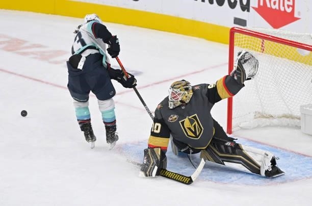 Robin Lehner of the Vegas Golden Knights defends a breakaway attempt by Brandon Tanev of the Seattle Kraken during the first period at T-Mobile Arena...