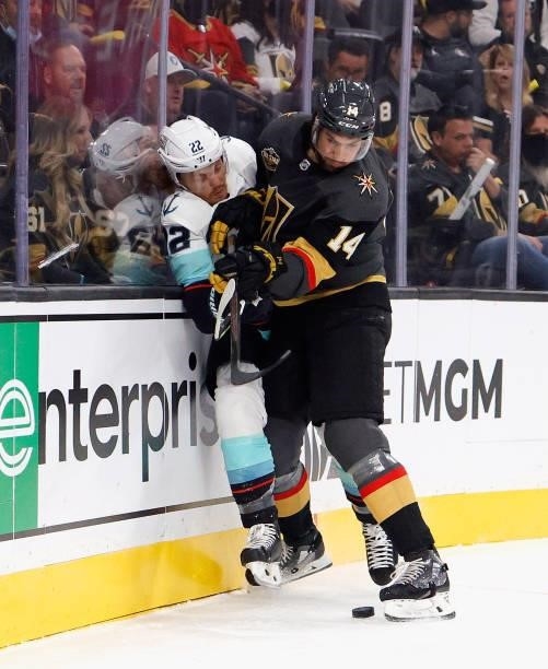 Mason Appleton of the Seattle Kraken is checked into the boards by Nicolas Hague of the Vegas Golden Knights during the first period of the Kraken's...
