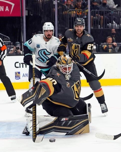 Robin Lehner of the Vegas Golden Knights makes the first period save as Marcus Johansson of the Seattle Kraken looks for the rebound during the first...