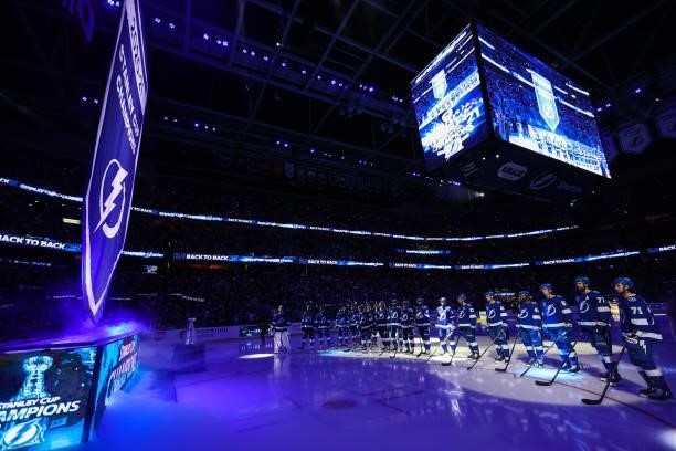 The Tampa Bay Lightning watch the banner rise to the rafters before the game against the Pittsburgh Penguins at Amalie Arena on October 12, 2021 in...