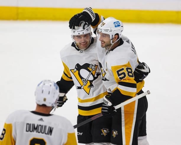 Dominik Simon and Kris Letang of the Pittsburgh Penguins celebrate a goal against the Tampa Bay Lightning at Amalie Arena on October 12, 2021 in...