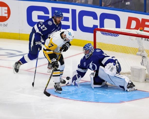 Goalie Andrei Vasilevskiy of the Tampa Bay Lightning makes a save against Bryan Rust of the Pittsburgh Penguins at Amalie Arena on October 12, 2021...
