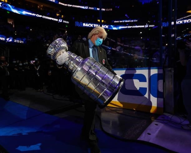 Keeper of the Cup Philip Pritchard carries the Stanley Cup out to the ice for the banner raising ceremony before the game between the Tampa Bay...