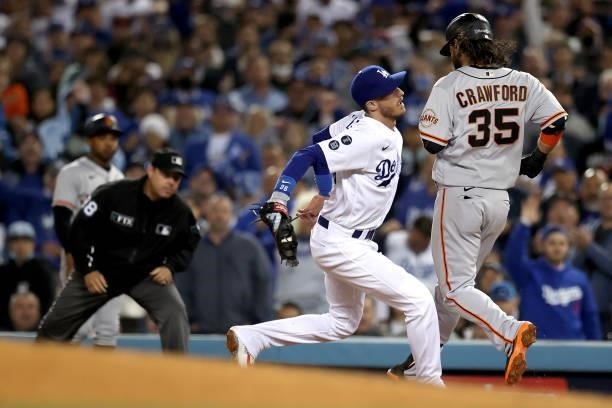 Cody Bellinger of the Los Angeles Dodgers makes the out on Brandon Crawford of the San Francisco Giants during the sixth inning in game 4 of the...