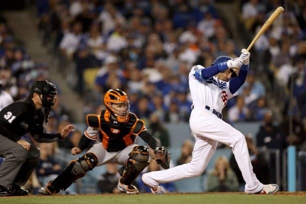 Cody Bellinger of the Los Angeles Dodgers watches his single against the San Francisco Giants during the fifth inning in game 4 of the National...