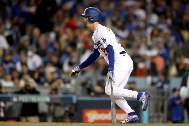 Walker Buehler of the Los Angeles Dodgers watches his single against the San Francisco Giants during the fourth inning in game 4 of the National...