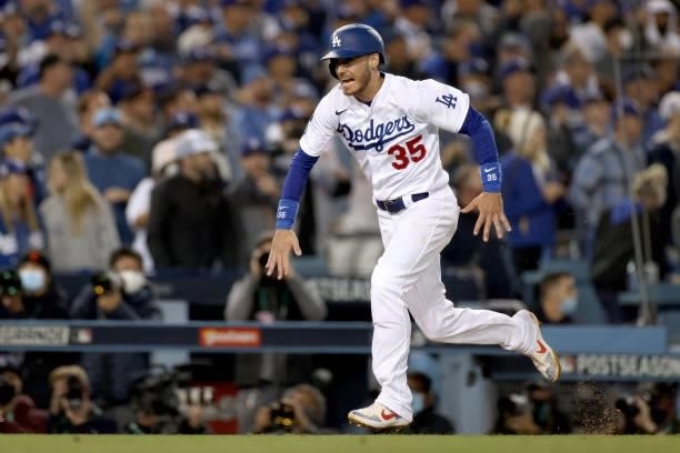 Cody Bellinger of the Los Angeles Dodgers scores on a sacrifice fly by Mookie Betts against the San Francisco Giants during the fifth inning game 4...