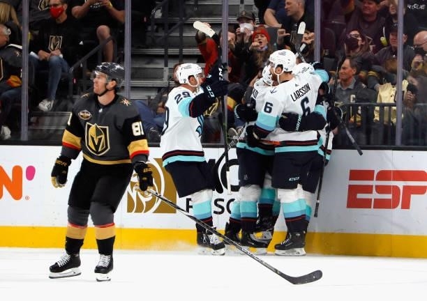 The Seattle Kraken celebrate a goal by Ryan Donato at 11:32 of the second period against the Vegas Golden Knights for the team's first-ever score...
