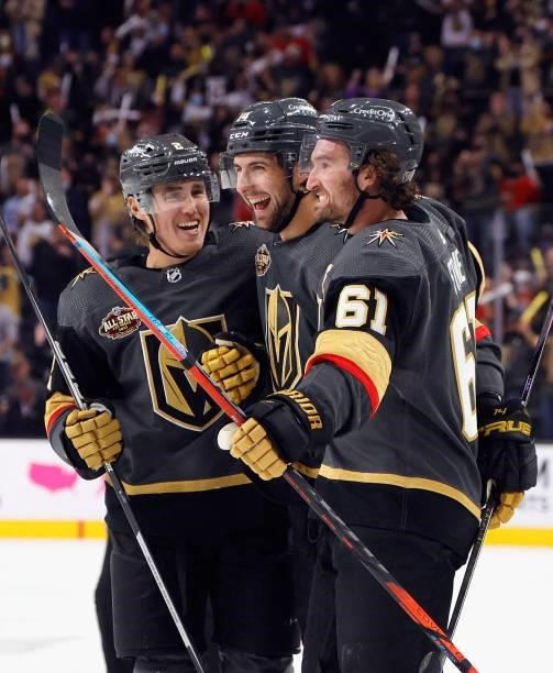 Zach Whitecloud, Nicolas Hague and Mark Stone of the Vegas Golden Knights celebrate after Hague and Stone assisted on a second-period goal by...