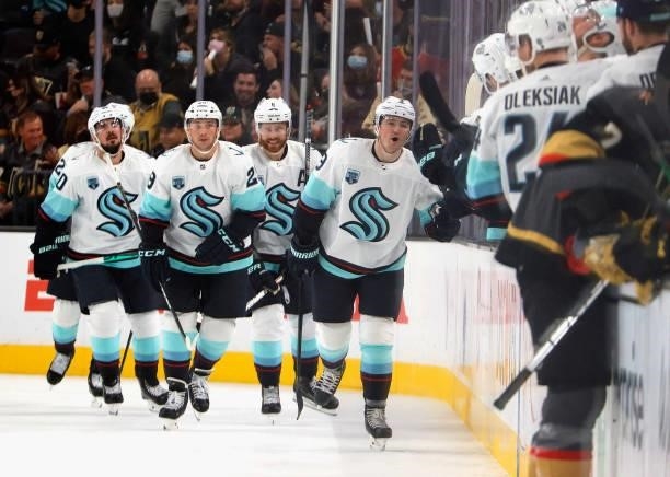 The Seattle Kraken celebrate a goal by Ryan Donato at 11:32 of the second period against the Vegas Golden Knights for the team's first-ever score...