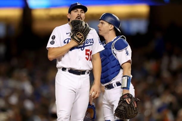 Alex Vesia and Will Smith of the Los Angeles Dodgers wait for a pitching change against the San Francisco Giants during the seventh inning in game 4...